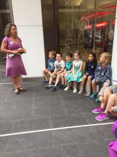 Cloudy speaking to children on tour