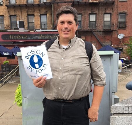 Liam Sullivan holding a boston by foot sign