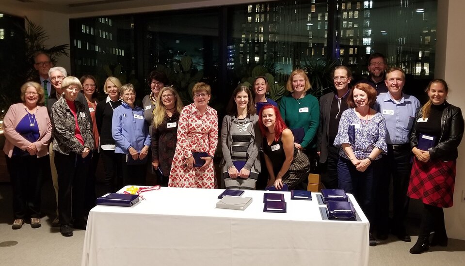 Boston By Foot 2019 Annual Awards Reception with people posing in front of a table with books