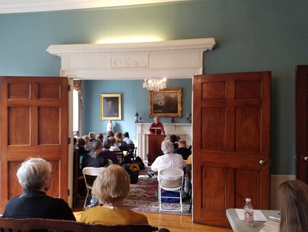 grand room with people seated watching lecture