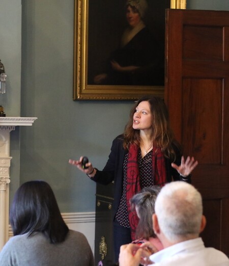 woman lecturing before a room full of people