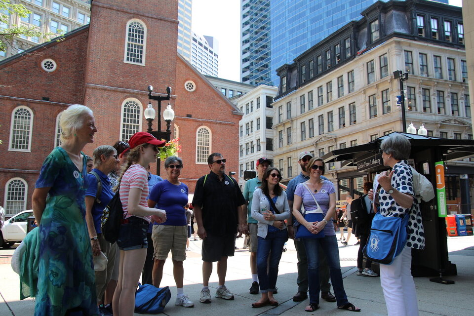 Tour guide speaking in front of a tour by the old south church boston