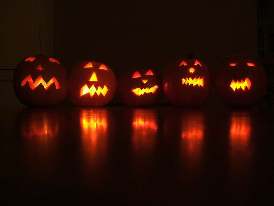 lit pumpkins in the dark