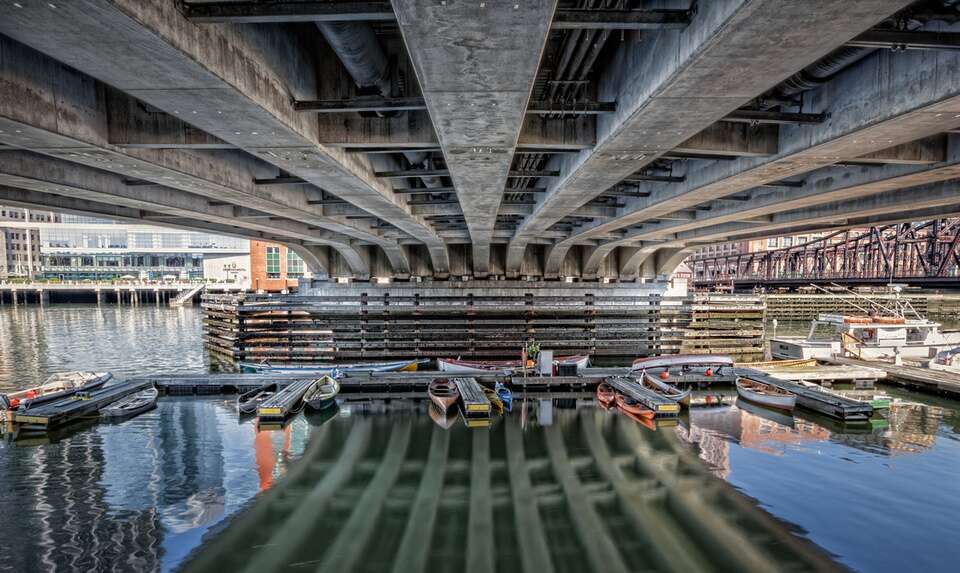 boats docked under the bridge to fort point Boston